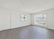 Thumbnail 28 of 38 - A room with a white door and a window with blinds.