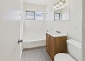 Thumbnail 26 of 38 - A white bathroom with a toilet, sink, and bathtub.