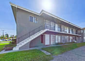 Thumbnail 33 of 38 - A modern building with a curved roof and a staircase leading to the entrance.