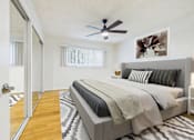 Thumbnail 9 of 41 - A bedroom with a large bed and a ceiling fan.