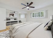 Thumbnail 7 of 41 - A bedroom with a large bed and a ceiling fan.