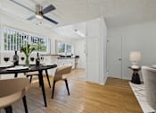 Thumbnail 3 of 41 - A modern dining room with a table set for two and a ceiling fan.