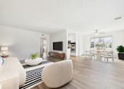 Thumbnail 3 of 72 - A modern living room with a white sofa and a television.