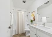Thumbnail 9 of 72 - A bathroom with a toilet, sink, and shower.