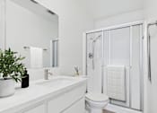 Thumbnail 10 of 72 - A white bathroom with a toilet, sink, and shower.