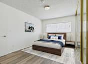 Thumbnail 6 of 72 - A bedroom with a bed, nightstand, and a picture on the wall.