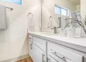 Thumbnail 13 of 70 - a bathroom with white cabinets and a sink and a mirror