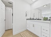 Thumbnail 8 of 95 - A white bathroom with a sink and mirror.