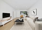 Thumbnail 13 of 95 - A modern living room with a black coffee table and a large flat screen TV.