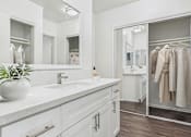 Thumbnail 27 of 95 - A bathroom with a white sink and a mirror above it.