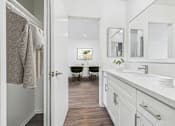 Thumbnail 28 of 95 - A bathroom with a white sink and a mirror above it.