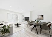 Thumbnail 2 of 44 - A modern living room with a black table and brown chairs.