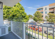Thumbnail 9 of 32 - the view from the balcony of an apartment building with cars parked on the street