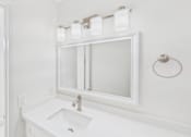 Thumbnail 36 of 81 - A white bathroom with a sink and mirror.