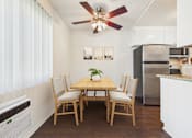Thumbnail 6 of 81 - A dining room with a wooden table and chairs.