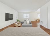 Thumbnail 15 of 81 - A living room with a grey couch and a wooden coffee table.