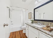 Thumbnail 22 of 81 - A bathroom with a toilet, sink, and shower.