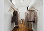 Thumbnail 20 of 81 - A hallway with two coats hanging on the wall.