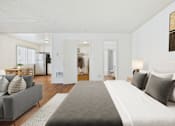 Thumbnail 19 of 81 - A bedroom with a large bed and a grey couch.