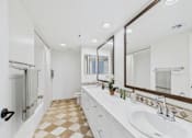 Thumbnail 13 of 24 - A bathroom with a checkered floor and a white vanity.