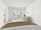 Thumbnail 8 of 29 - A bedroom with a bed, a cabinet, and a balcony with a gate.