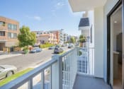 Thumbnail 10 of 32 - a view of a street from a balcony with a white railing