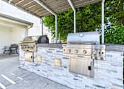 Thumbnail 83 of 90 - A stainless steel grill is attached to a stone wall.