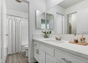 Thumbnail 5 of 73 - A bathroom with a white sink and a mirror above it.