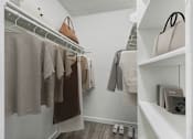 Thumbnail 4 of 73 - Clothes hanging on a rack in a room.