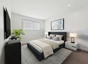 Thumbnail 8 of 91 - A modern bedroom with a large bed, a television, and a plant.