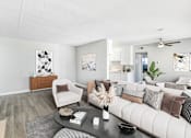 Thumbnail 20 of 50 - a living room with a white couch and a coffee table