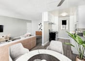 Thumbnail 18 of 50 - a living room and kitchen with a table and chairs