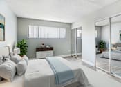 Thumbnail 22 of 50 - a bedroom with a bed and a sliding glass door