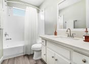 Thumbnail 24 of 50 - a bathroom with a sink and a toilet and a shower