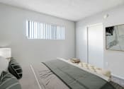 Thumbnail 16 of 50 - a bedroom with a bed and a sliding glass door
