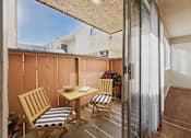 Thumbnail 6 of 60 - A patio with a table and chairs.