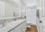 Thumbnail 10 of 60 - A bathroom with a white toilet and sink.