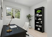 Thumbnail 7 of 20 - A black desk with a lamp and a chair in front of a window with a view of trees and houses outside.