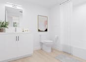 Thumbnail 10 of 18 - A white bathroom with a toilet, a cabinet, a plant, and a painting on the wall.