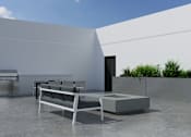 Thumbnail 11 of 18 - A modern outdoor seating area with a white sofa and a table.