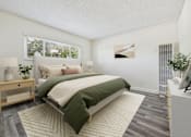 Thumbnail 8 of 36 - A bedroom with a large bed and a nightstand with a lamp.
