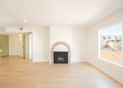 Thumbnail 12 of 28 - a living room with a fireplace and a wooden floor