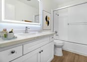 Thumbnail 7 of 44 - A white bathroom with a toilet, sink, and mirror.