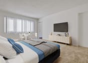 Thumbnail 6 of 24 - a bedroom with a bed and a television on the wall