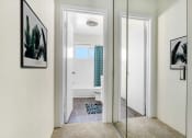 Thumbnail 7 of 24 - a bathroom with a mirror and a rug on the floor