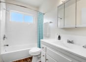 Thumbnail 10 of 24 - a bathroom with a sink toilet and a bath tub