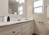 Thumbnail 14 of 24 - a bathroom with a sink and a mirror and a toilet