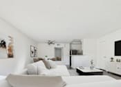Thumbnail 3 of 35 - A modern living room with a grey sofa and a white coffee table.