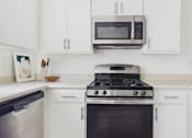 Thumbnail 1 of 45 - A modern kitchen with a stove, oven, and microwave.