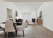 Thumbnail 4 of 45 - A dining room with a table and chairs.